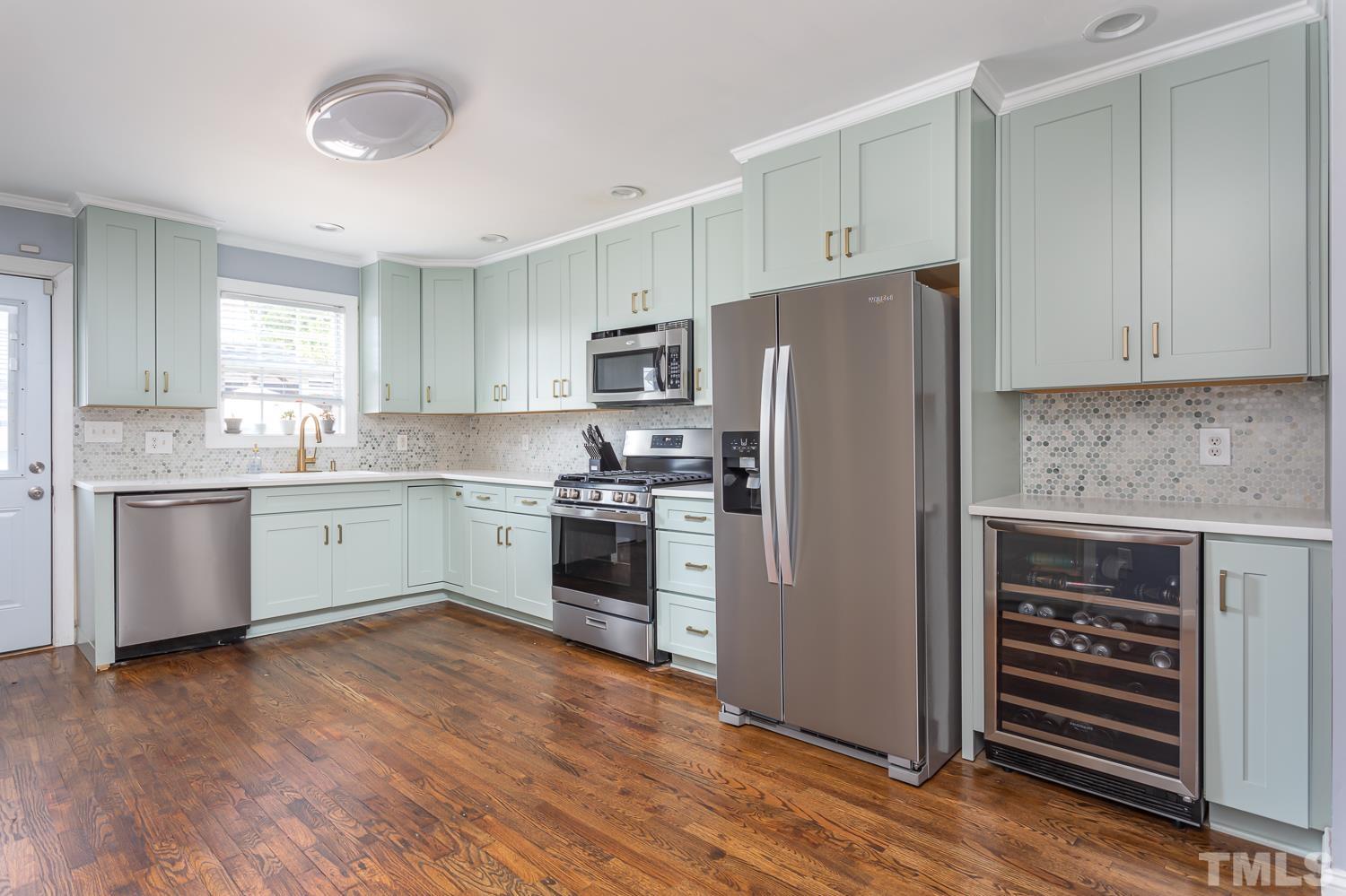 610 East Martin Street Raleigh, NC 27601 - Photo 14 of 40 a kitchen with a refrigerator stove top oven and cabinets