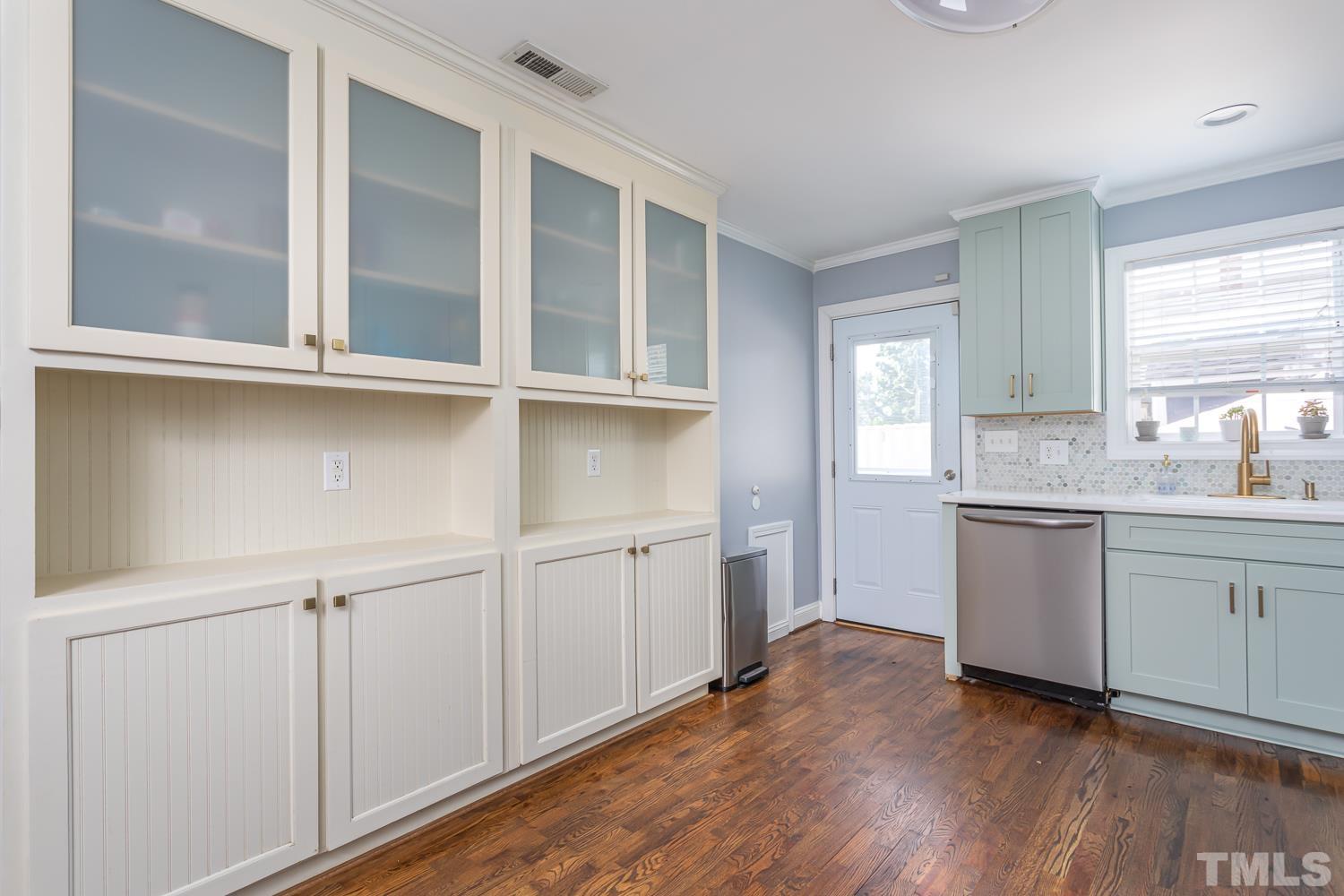 610 East Martin Street Raleigh, NC 27601 - Photo 15 of 40 a kitchen with white cabinets and white appliances