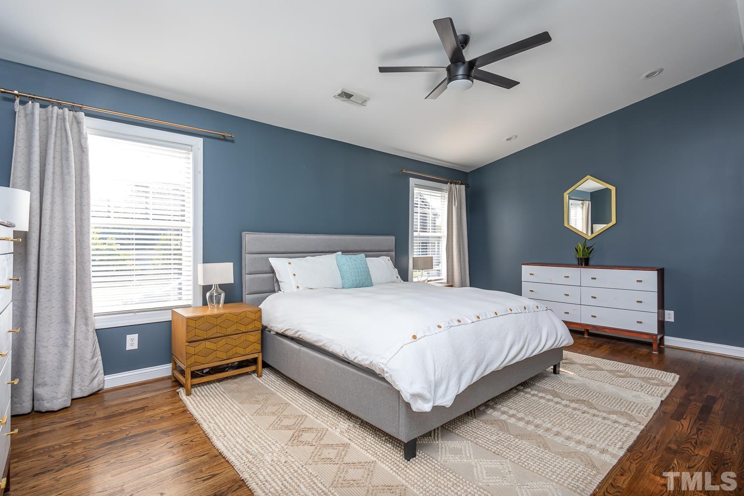 610 East Martin Street Raleigh, NC 27601 - Photo 16 of 40 a bedroom with a bed and a chandelier