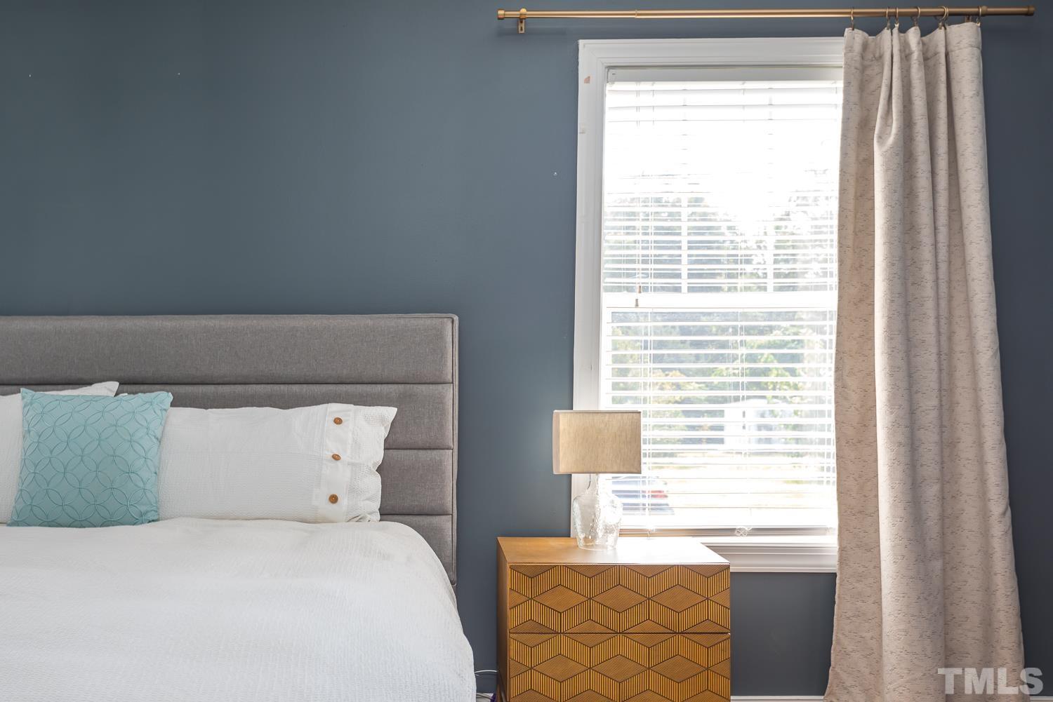 610 East Martin Street Raleigh, NC 27601 - Photo 17 of 40 a bedroom with a bed and a window