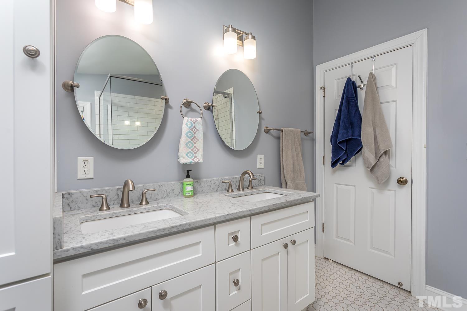 610 East Martin Street Raleigh, NC 27601 - Photo 19 of 40 a bathroom with 2 sink and a mirror