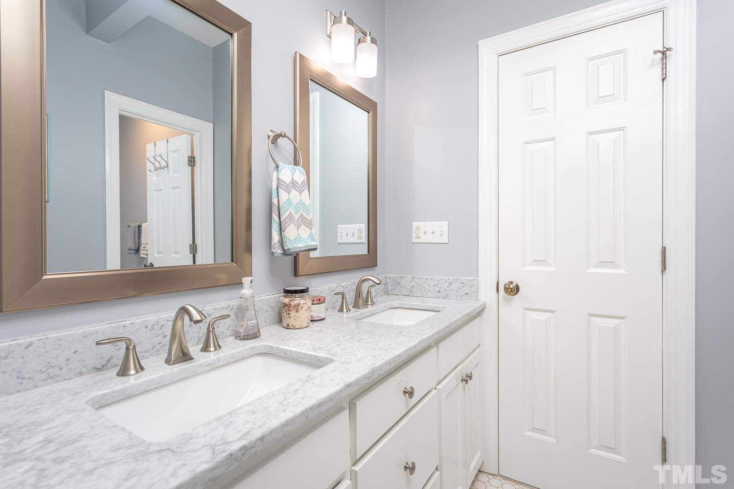 610 East Martin Street Raleigh, NC 27601 - Photo 23 of 40 a bathroom with double vanity sinks and a mirror