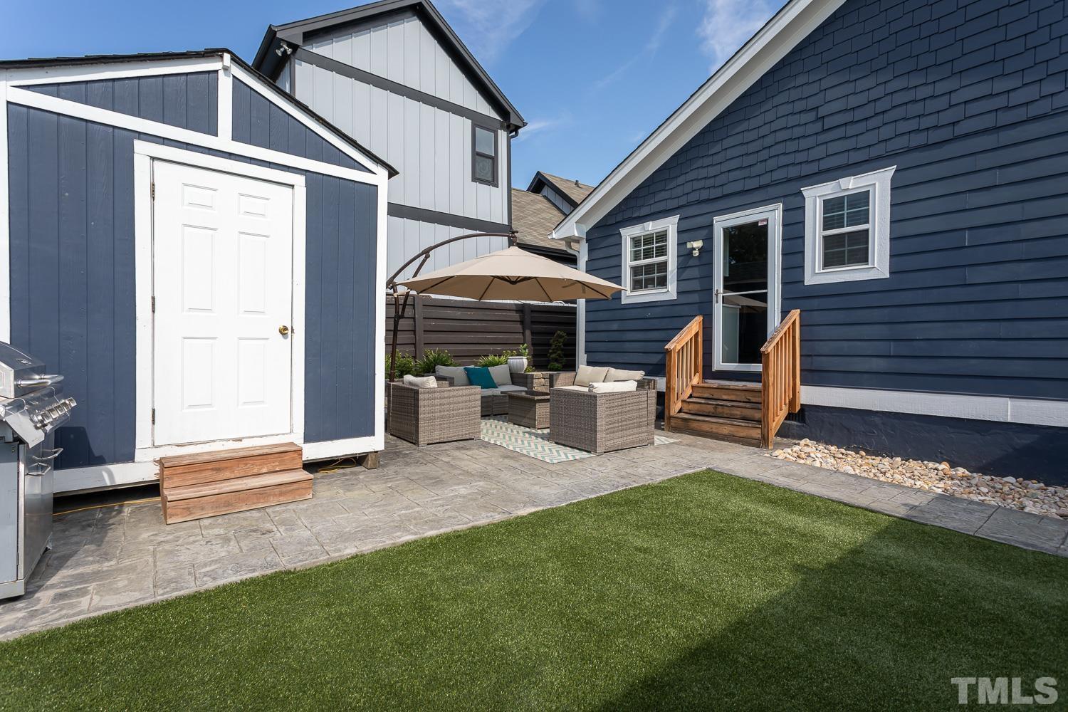 610 East Martin Street Raleigh, NC 27601 - Photo 26 of 40 a view of a house with a yard and sitting area