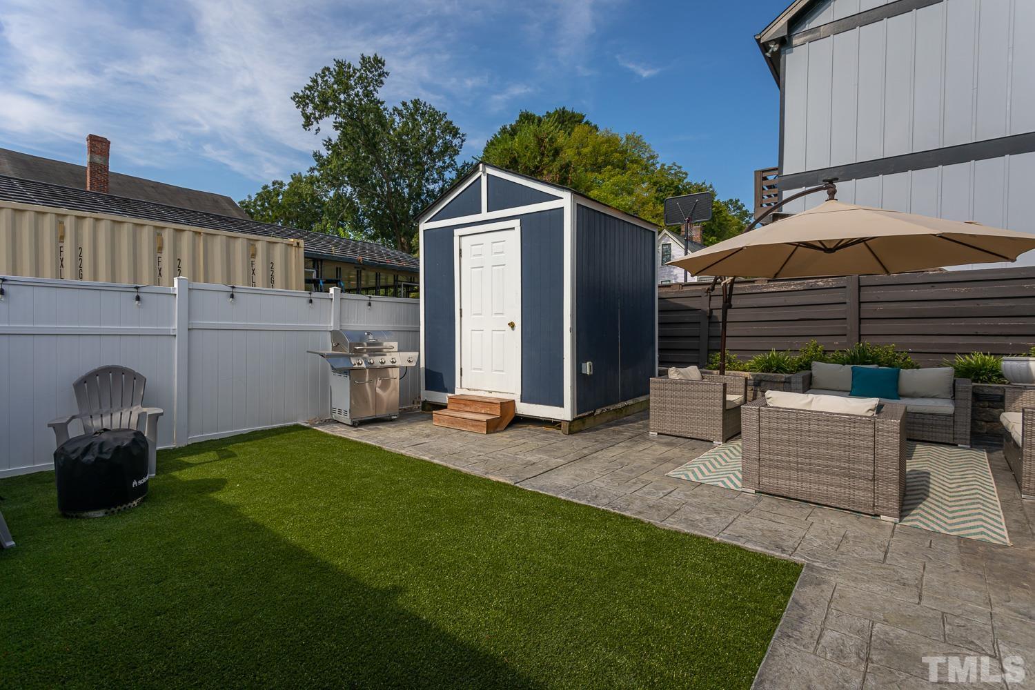 610 East Martin Street Raleigh, NC 27601 - Photo 27 of 40 a patio with a table and chairs under an umbrella