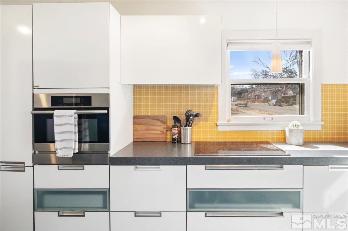 1250 Watt Street Reno, NV 89509 - Photo 12 of 33 a kitchen with granite countertop a stove and a microwave