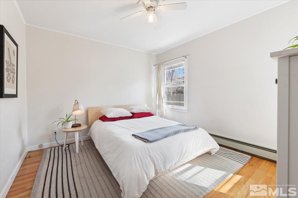 1250 Watt Street Reno, NV 89509 - Photo 19 of 33 a bedroom with a bed and a chandelier