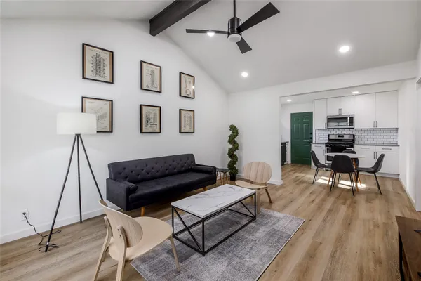a living room with furniture and wooden floor