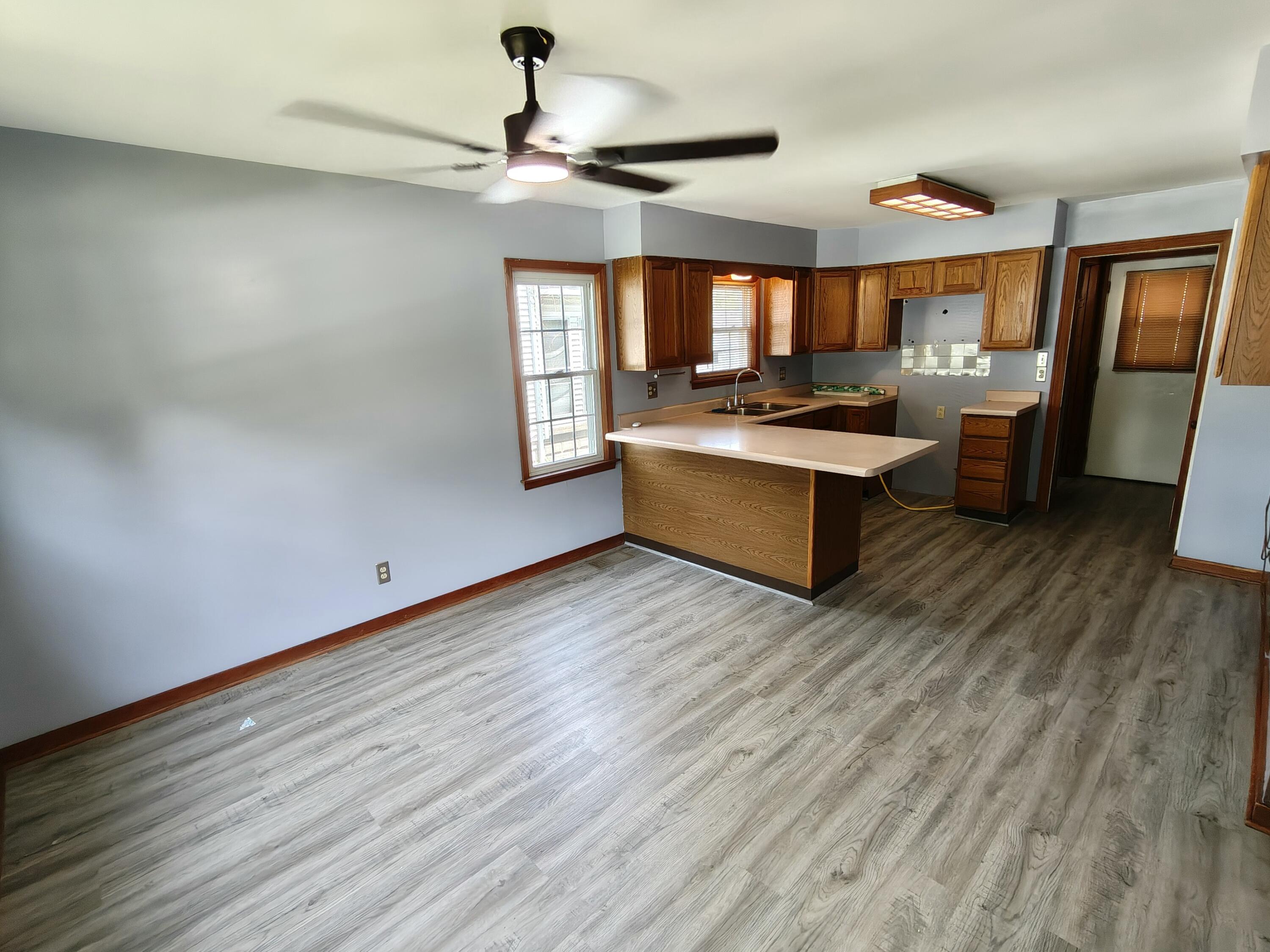 245 North Indiana Street Griffith, IN 46319 - Photo 7 of 30 a large kitchen with a wooden floor and stainless steel appliances