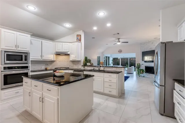 a kitchen with a sink stove and refrigerator