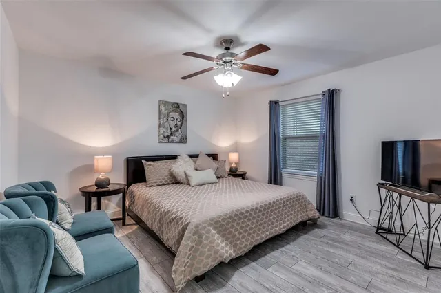 a bedroom with a bed and a flat screen tv