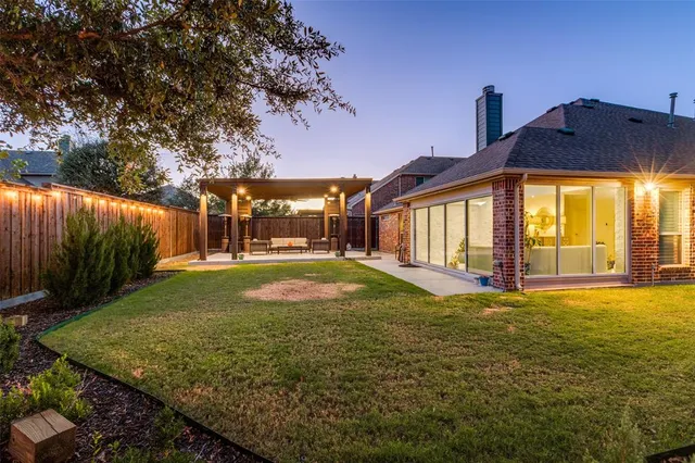 a view of a house with backyard and sitting area