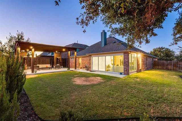 a view of a house with backyard and sitting area