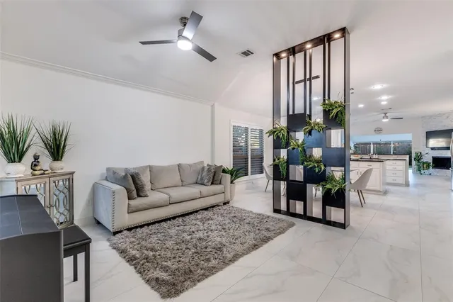 a living room with furniture or kitchen view and a potted plant