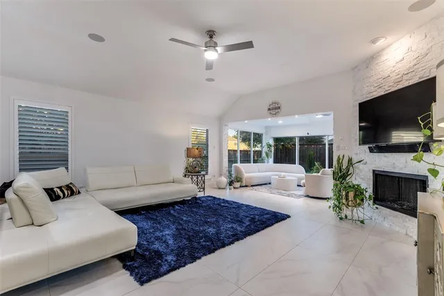 a living room with furniture a fireplace and a flat screen tv