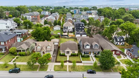 an aerial view of a house with garden space and street view