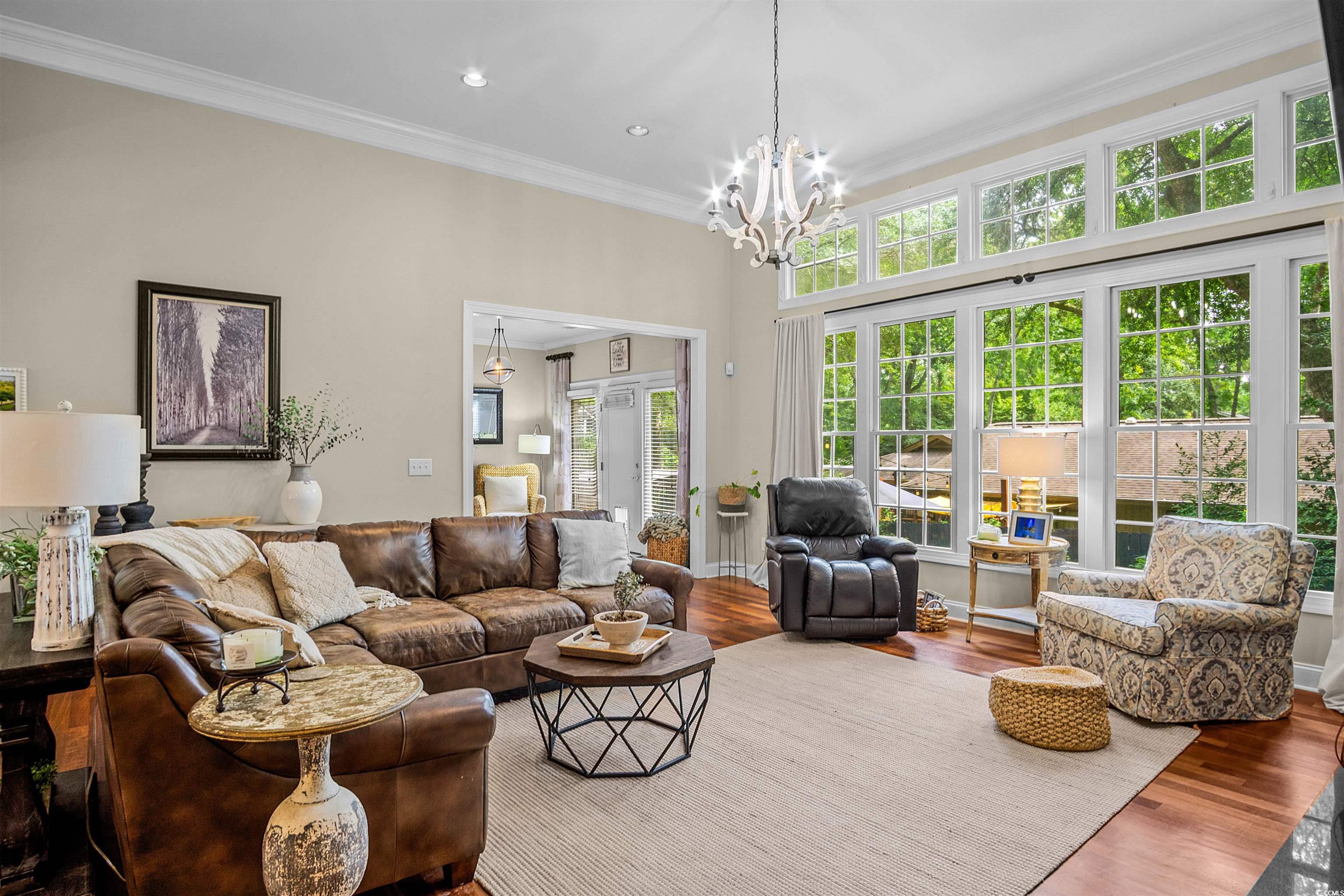 1079 Waterway Lane Myrtle Beach, SC 29572 - Photo 12 of 38 Living area featuring wood finished floors, crown molding, a fireplace, a chandelier, and recessed lighting
