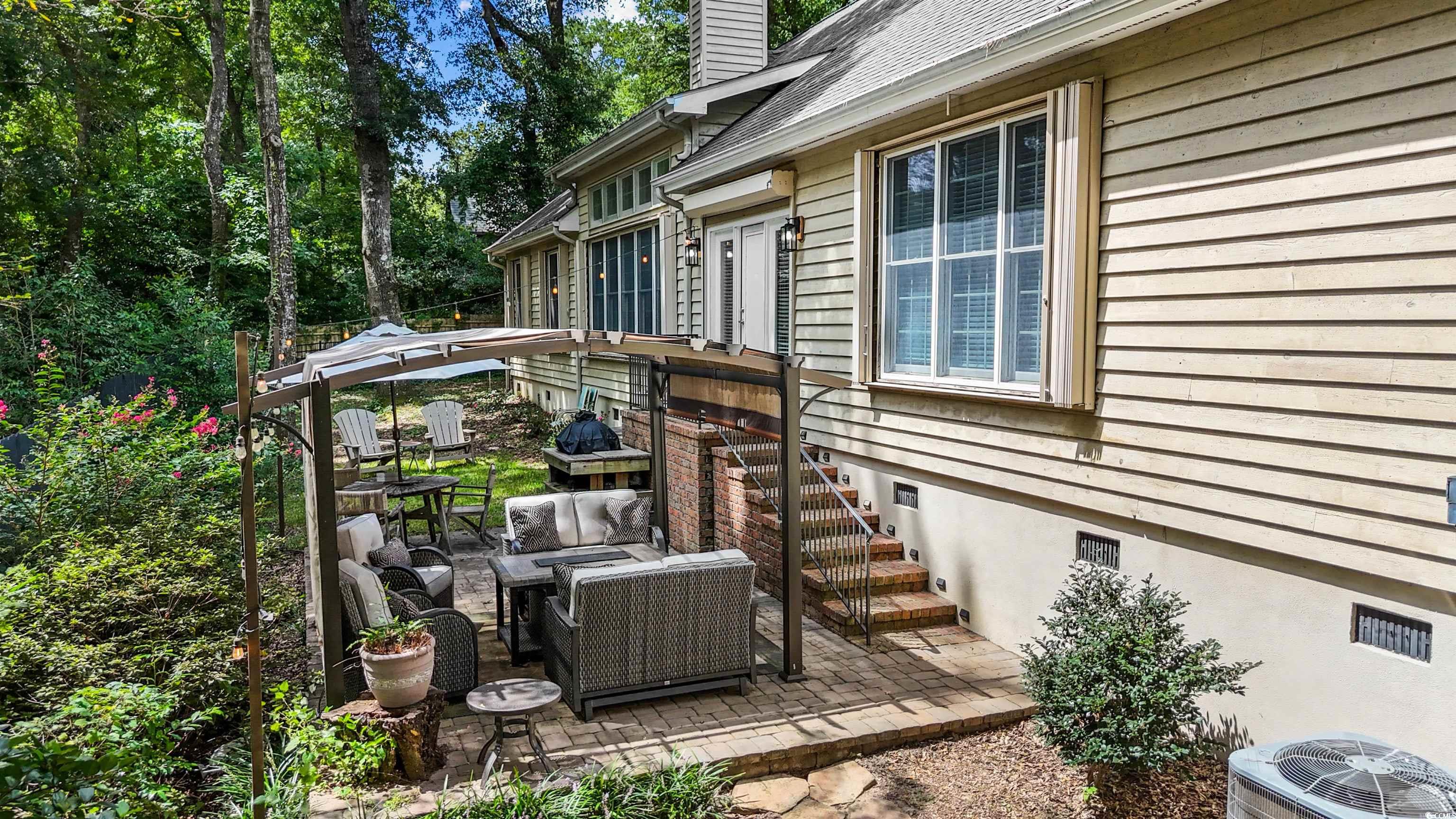 1079 Waterway Lane Myrtle Beach, SC 29572 - Photo 32 of 38 View of property exterior featuring roof with shingles, a garage, and driveway