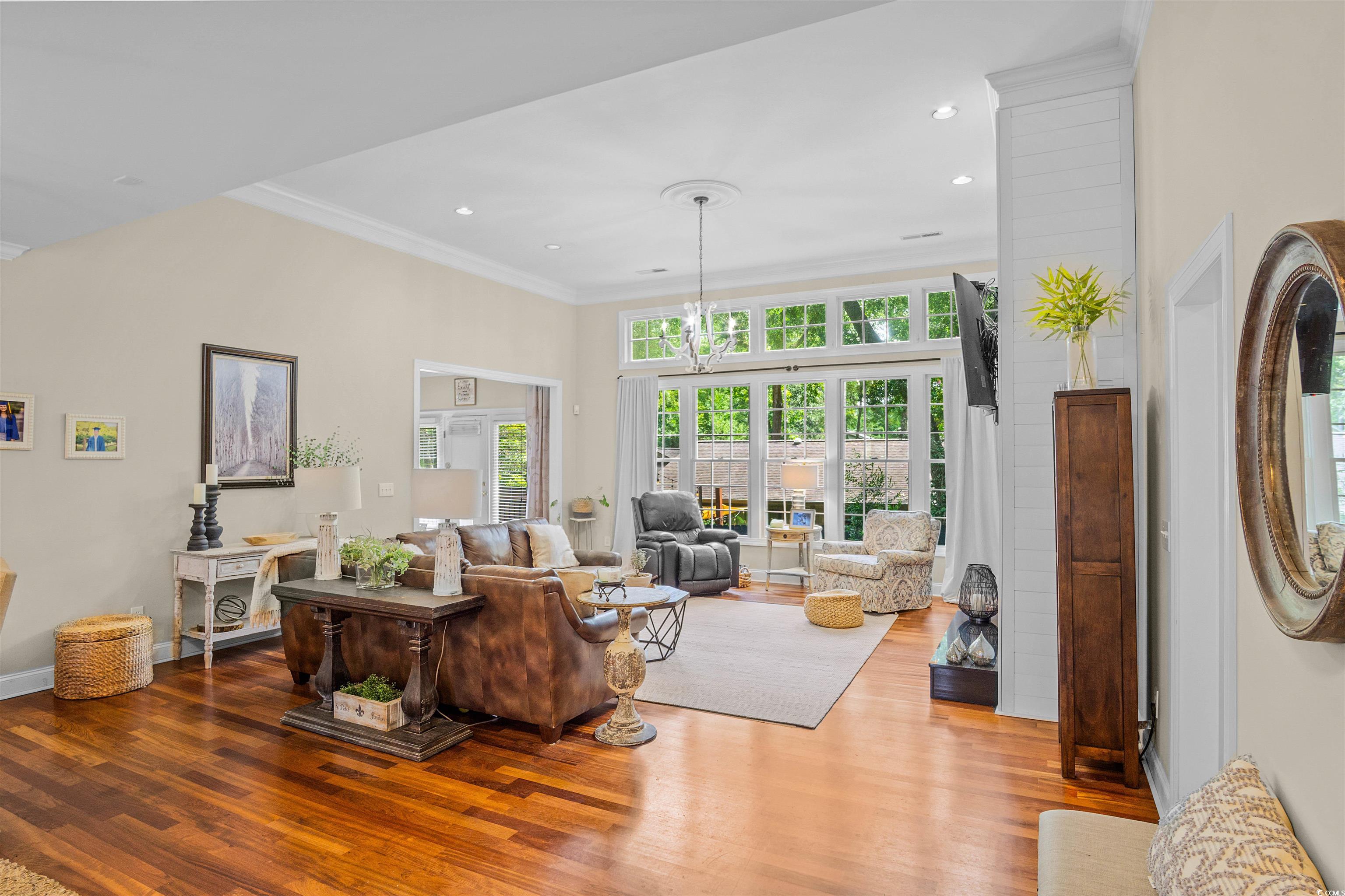 1079 Waterway Lane Myrtle Beach, SC 29572 - Photo 10 of 38 Living room featuring crown molding, a chandelier, and wood finished floors