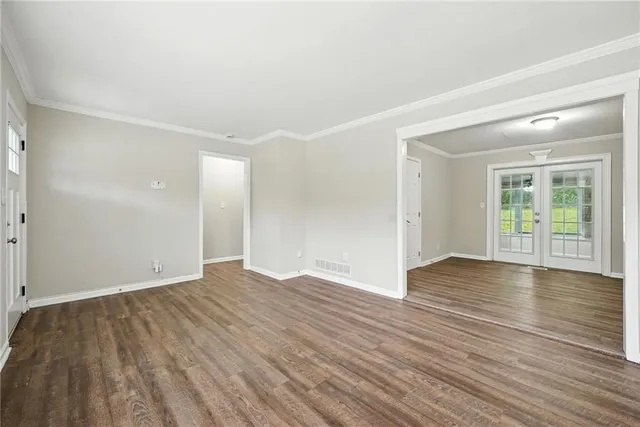wooden floor in an empty room with a window