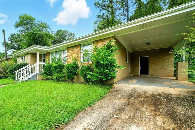 a front view of a house with a yard table and chairs