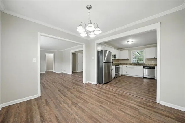 a view of a kitchen with wooden floor and a kitchen