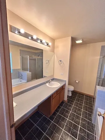 a bathroom with a sink mirror and a bath tub