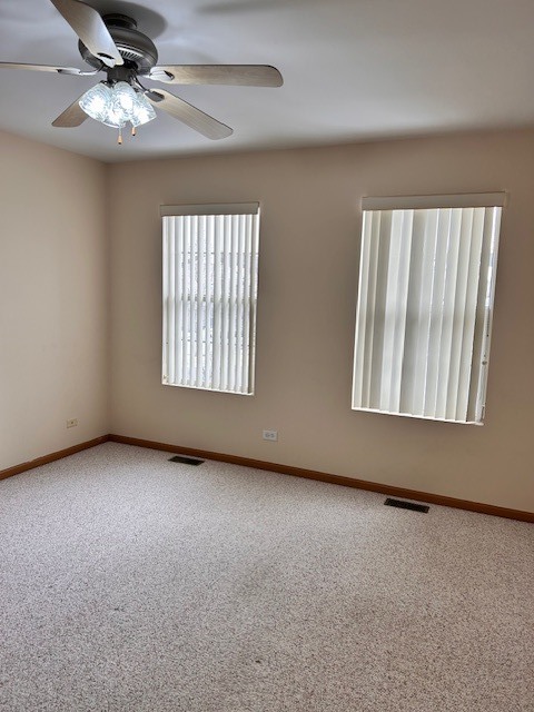 623 Waterview Court Naperville, IL 60563 - Photo 17 of 22 an empty room with windows and fan