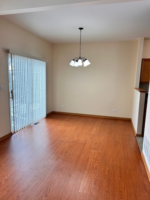 623 Waterview Court Naperville, IL 60563 - Photo 6 of 22 a view of an empty room with wooden floor and a window