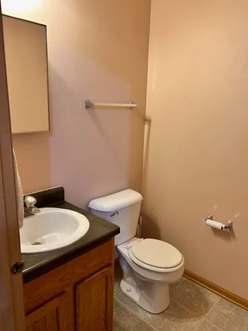 a white toilet sitting next to a bathroom sink