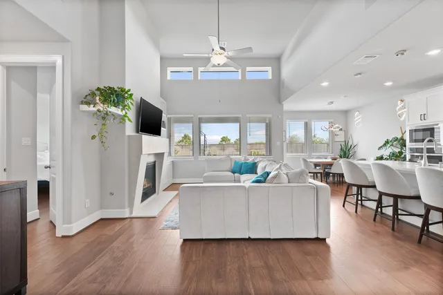 a living room with fireplace furniture and a wooden floor