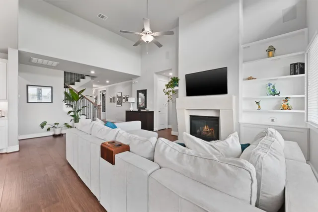 a living room with furniture a flat screen tv and a fireplace
