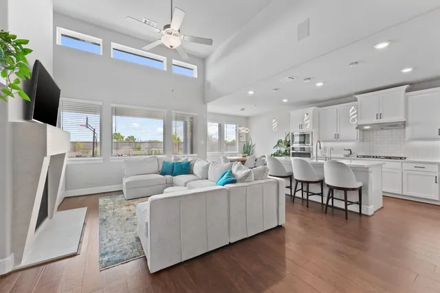 a living room with furniture dining table and a refrigerator