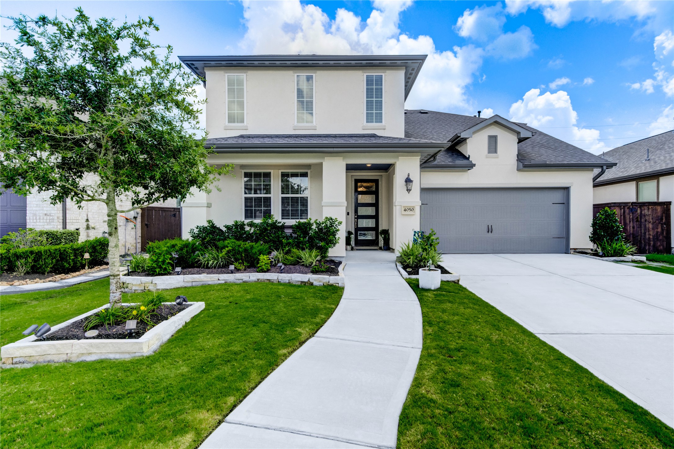 4050 Shackleton Court Iowa Colony, TX 77583 - Photo 2 of 48 a front view of a house with a yard and potted plants