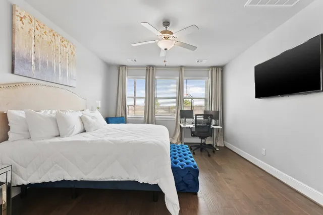 a bedroom with a large bed and a flat screen tv