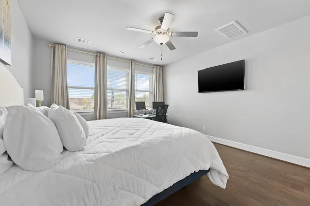 a bedroom with a large bed and a flat screen tv