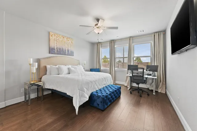 a bedroom with a bed and a flat screen tv