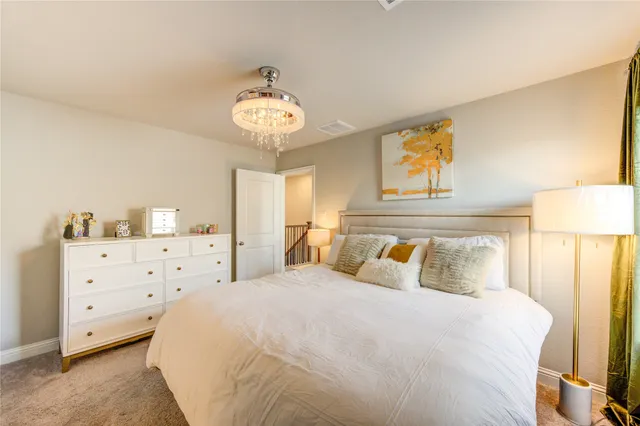a bedroom with a bed and a chandelier