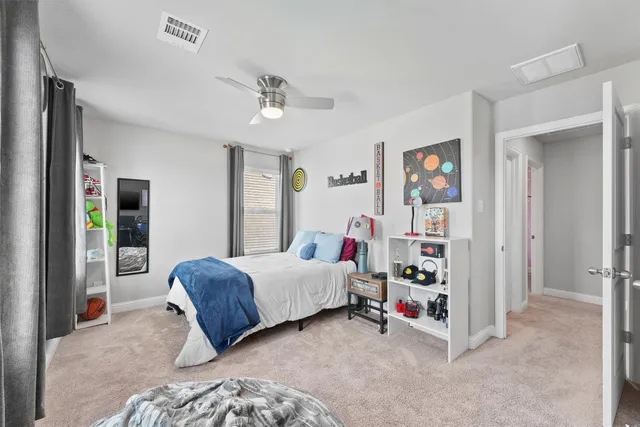 a bedroom with a large bed and a window