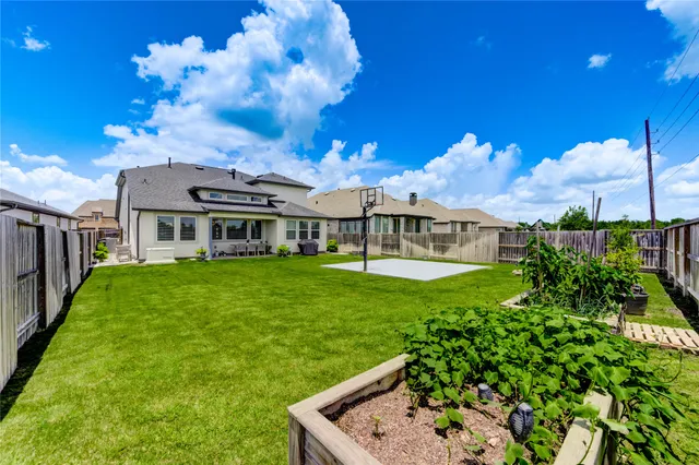 a view of a house with a yard and sitting area