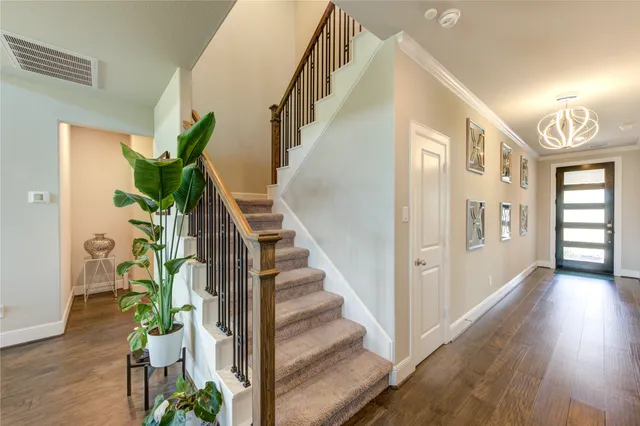 a view of entryway and hall with wooden floor