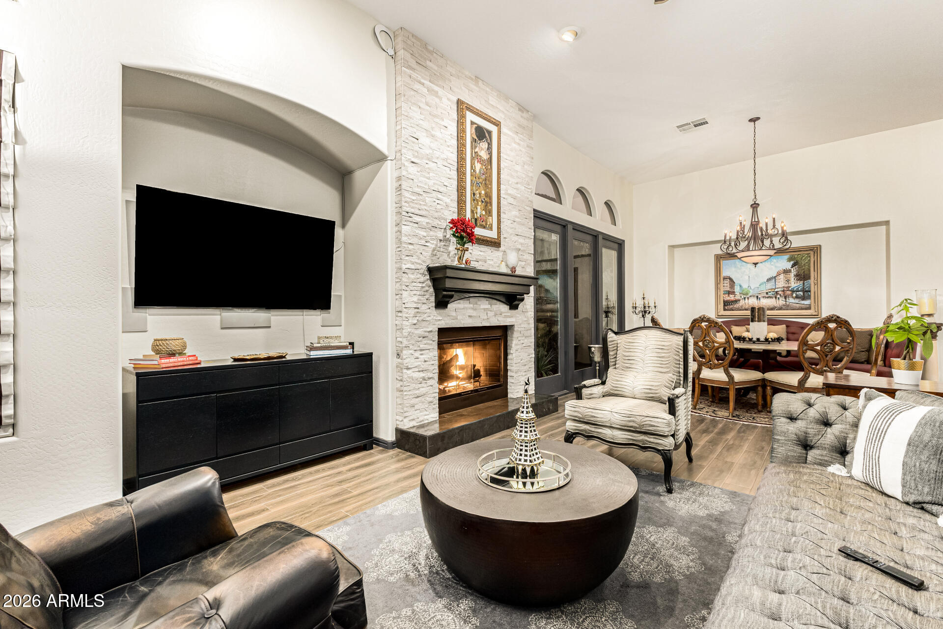 3418 East Pyrenees Pass Phoenix, AZ 85018 - Photo 11 of 46 a living room with furniture a fireplace and a flat screen tv