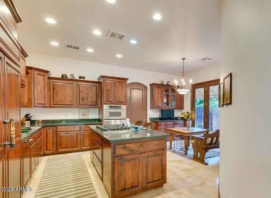 3418 East Pyrenees Pass Phoenix, AZ 85018 - Photo 13 of 46 a kitchen with stainless steel appliances granite countertop a sink stove and cabinets