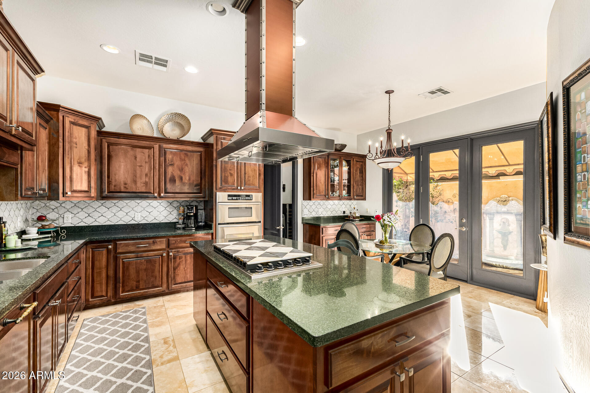 3418 East Pyrenees Pass Phoenix, AZ 85018 - Photo 16 of 46 a kitchen with stainless steel appliances granite countertop a sink a stove and a wooden floors