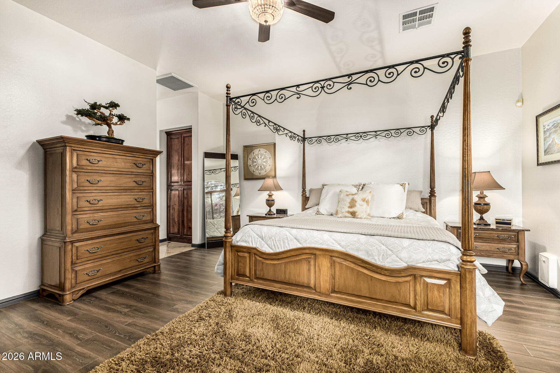3418 East Pyrenees Pass Phoenix, AZ 85018 - Photo 19 of 46 a spacious bedroom with a bed and a chandelier