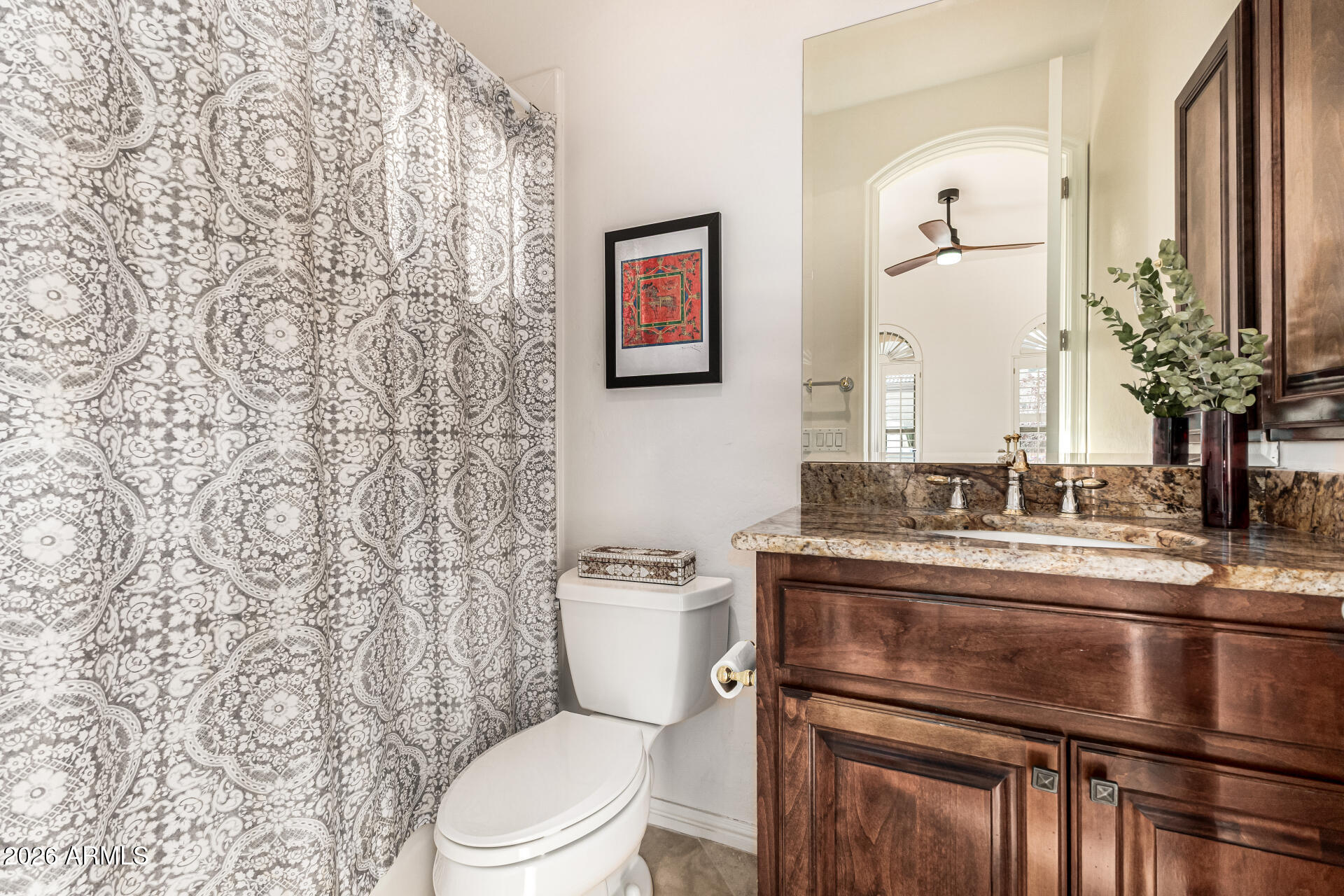 3418 East Pyrenees Pass Phoenix, AZ 85018 - Photo 26 of 46 a bathroom with a toilet sink and mirror