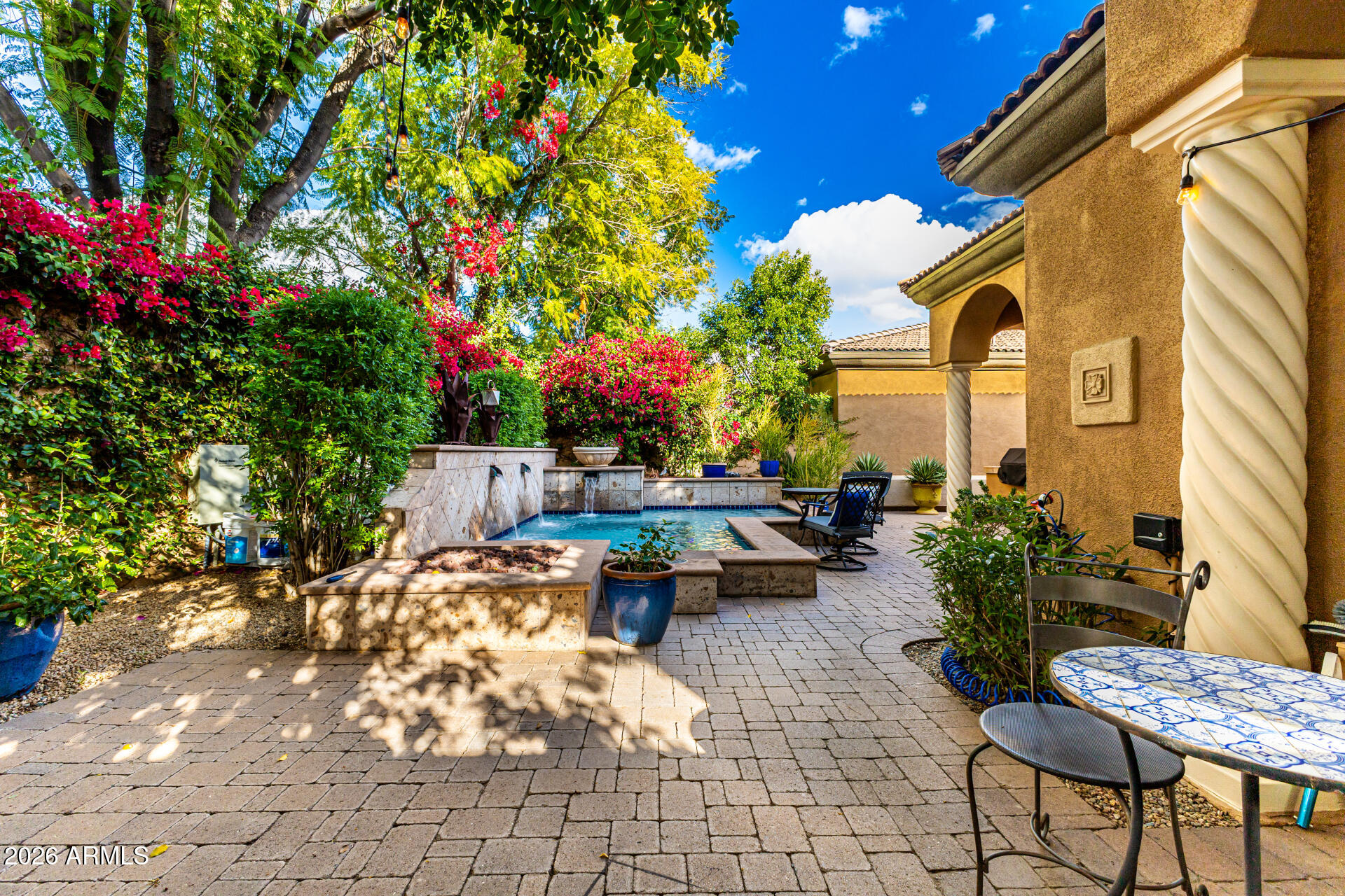 3418 East Pyrenees Pass Phoenix, AZ 85018 - Photo 43 of 46 a backyard of a house with fire pit and outdoor seating