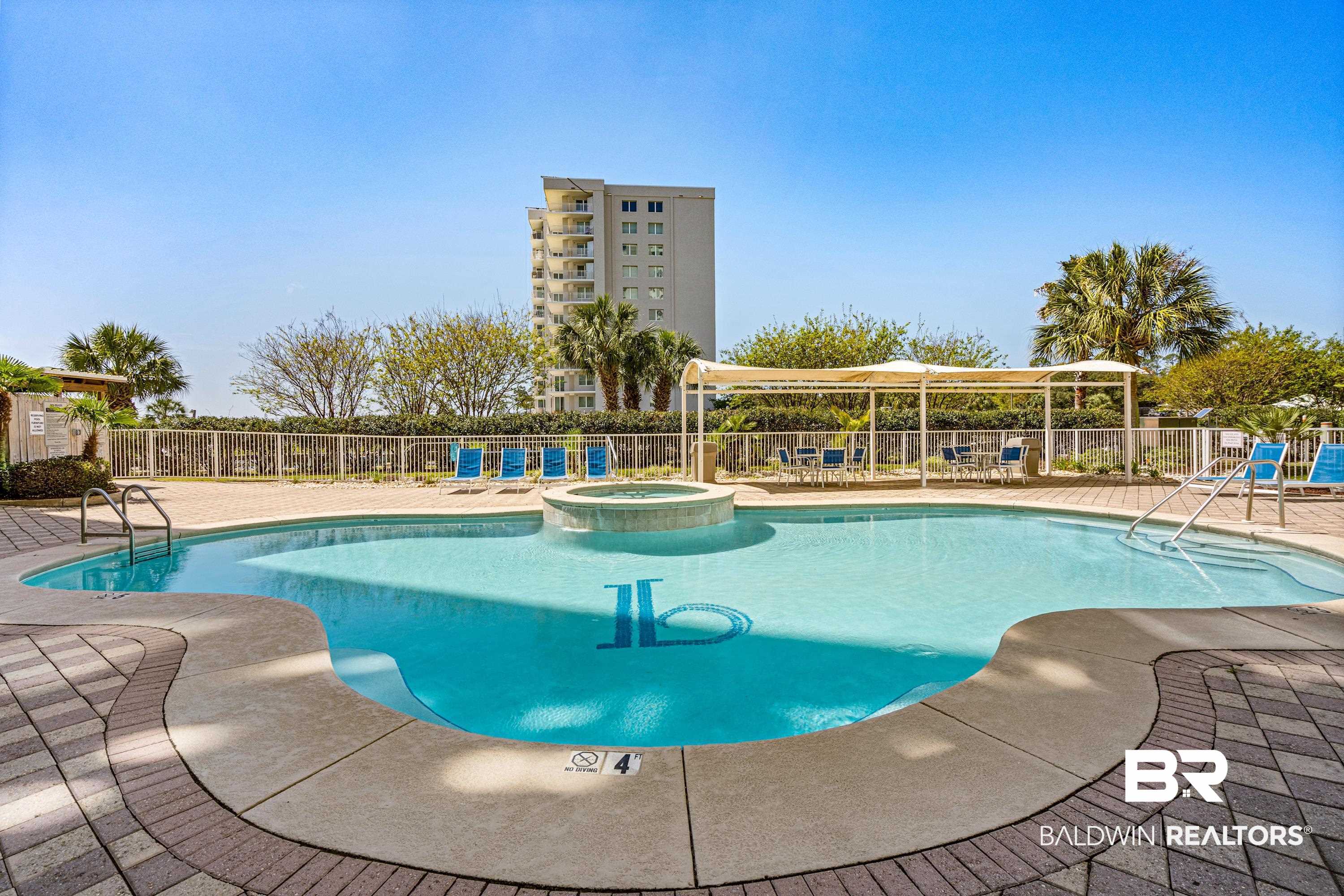 28250 Canal Road, Unit 101 Orange Beach, AL 36561 - Photo 33 of 34 View of pool featuring a patio, fence, and a pool with connected hot tub