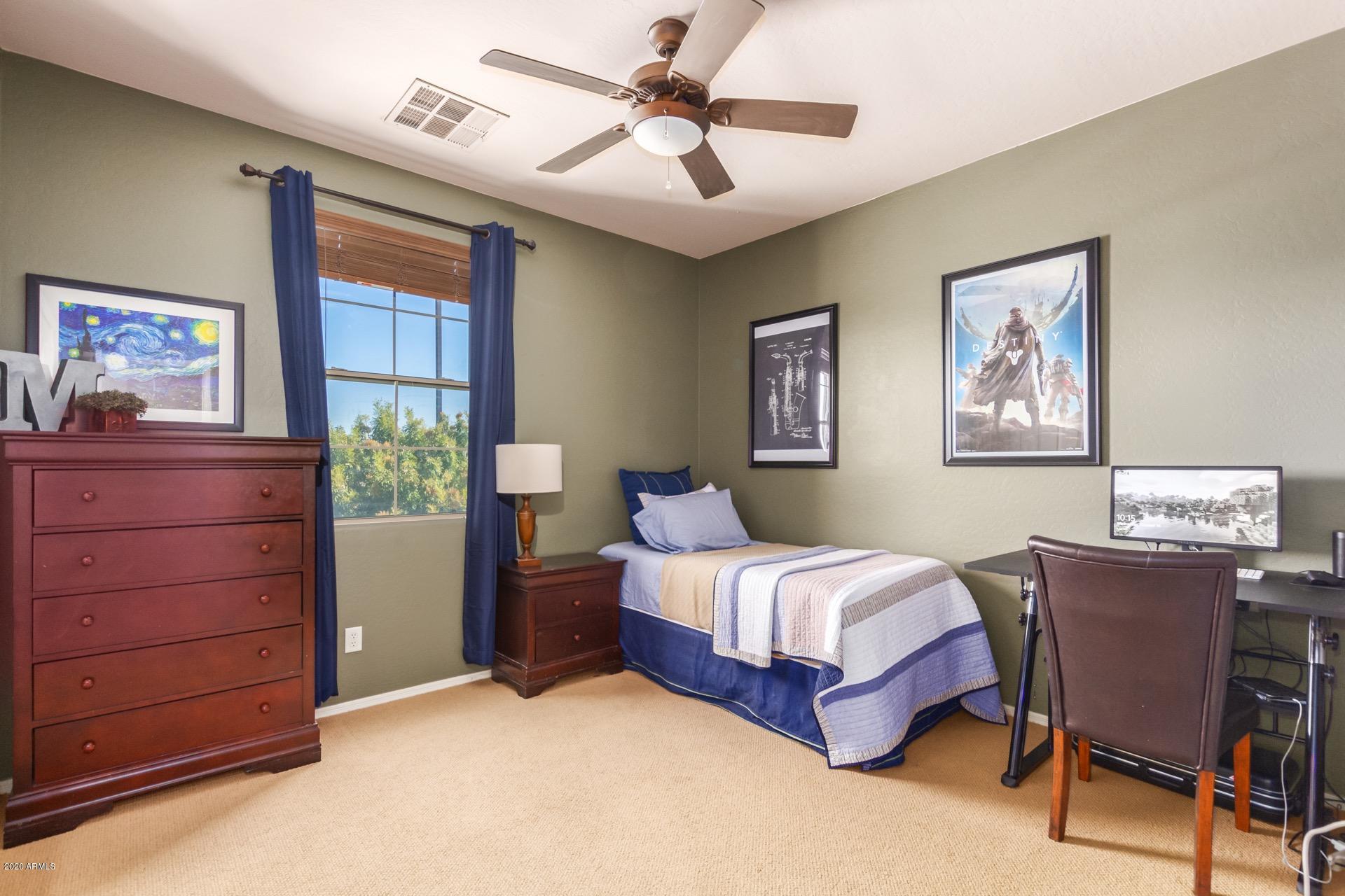 1043 Phelps Street Gilbert, AZ 85295 - Photo 11 of 18 a bedroom with a bed and a table