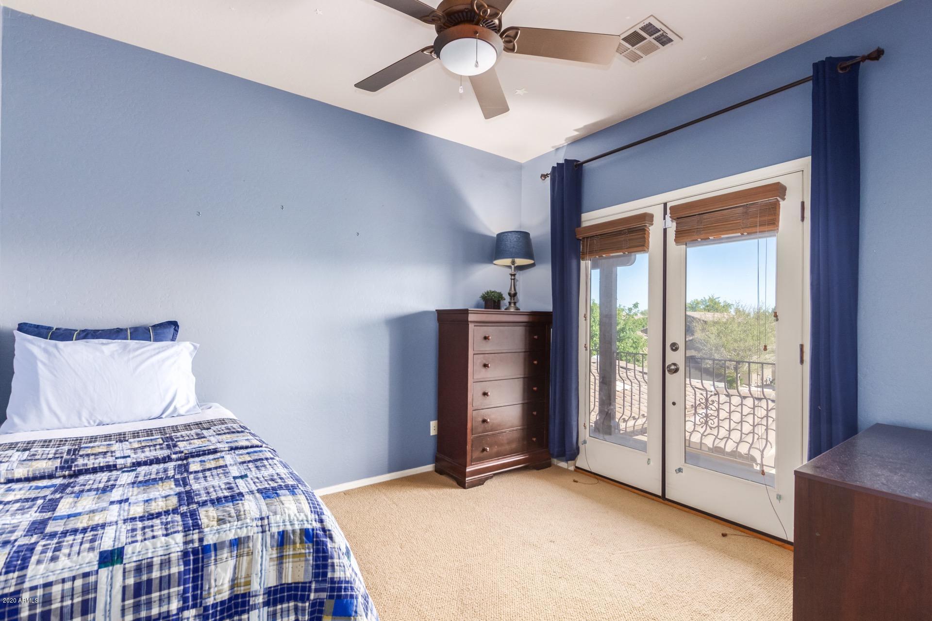1043 Phelps Street Gilbert, AZ 85295 - Photo 12 of 18 a bedroom with a balcony a bed and a chandelier