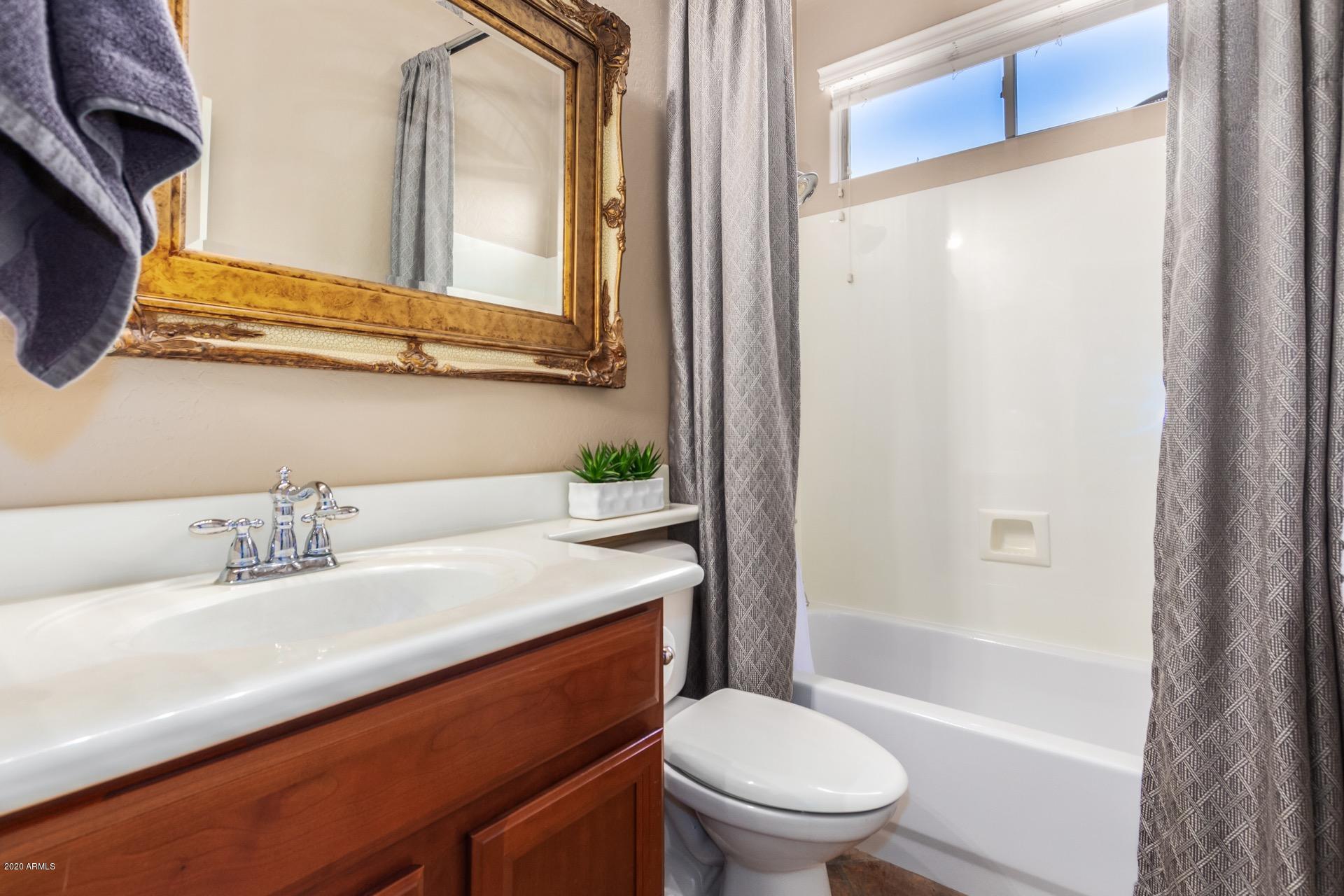 1043 Phelps Street Gilbert, AZ 85295 - Photo 16 of 18 a bathroom with a sink a toilet and shower